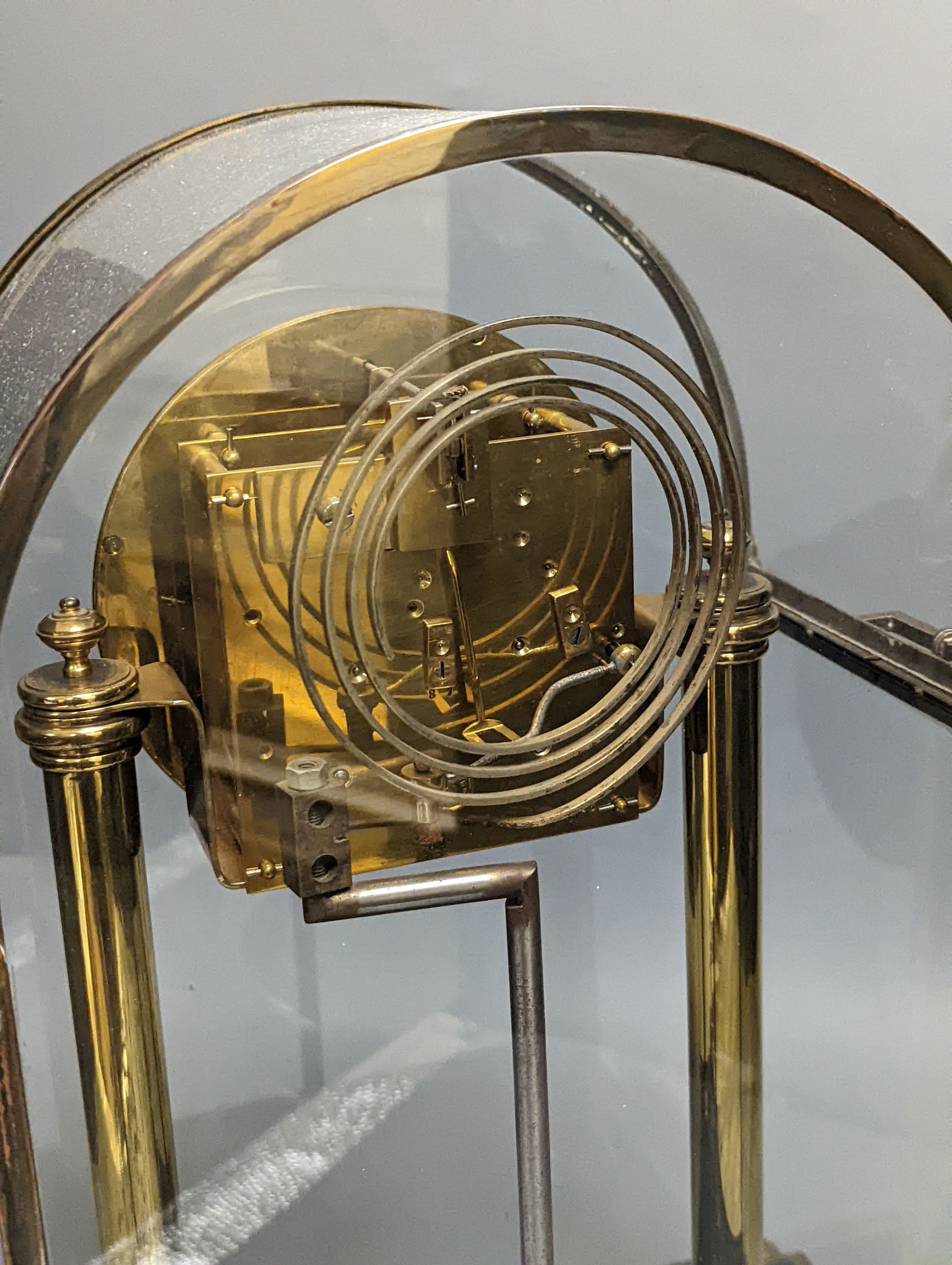 A large four glass clock, with decorative enamel dial, 43.5 cms high.